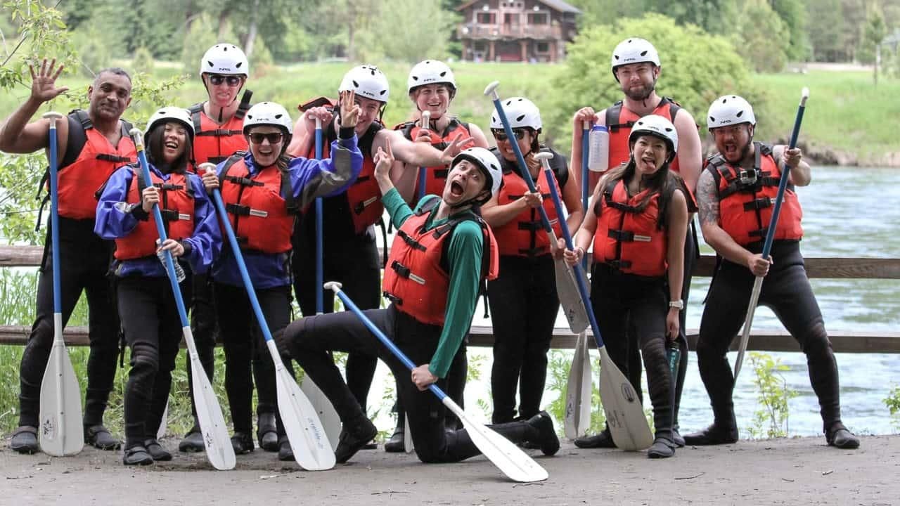 Happy employees getting ready for a rafting trip